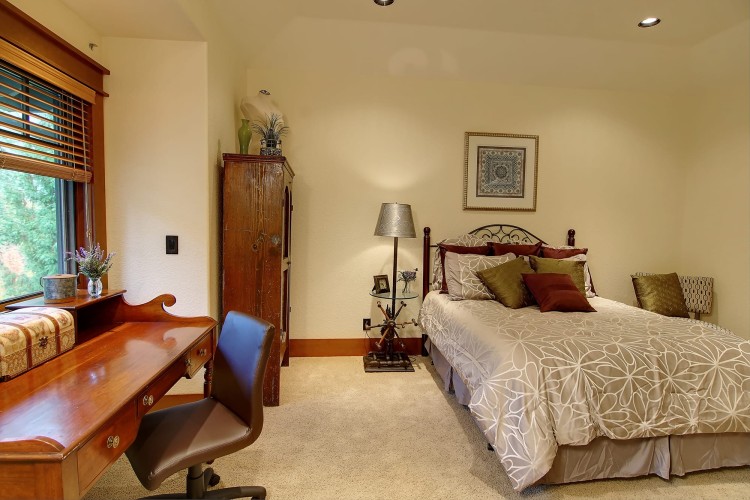 Bedroom with a wooden desk and simple furnishings