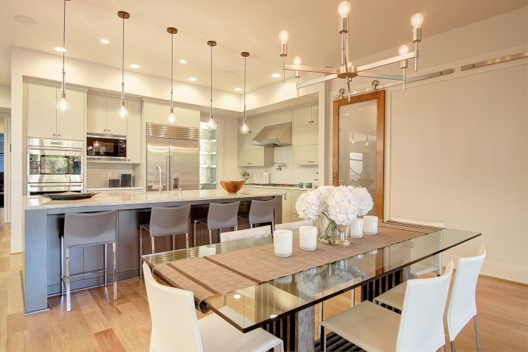 Very light colored kitchen and dining space with simple, elegant touches of style