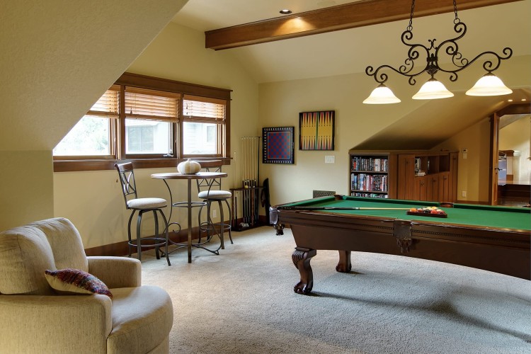 Gaming room with a billiards table and plush seating