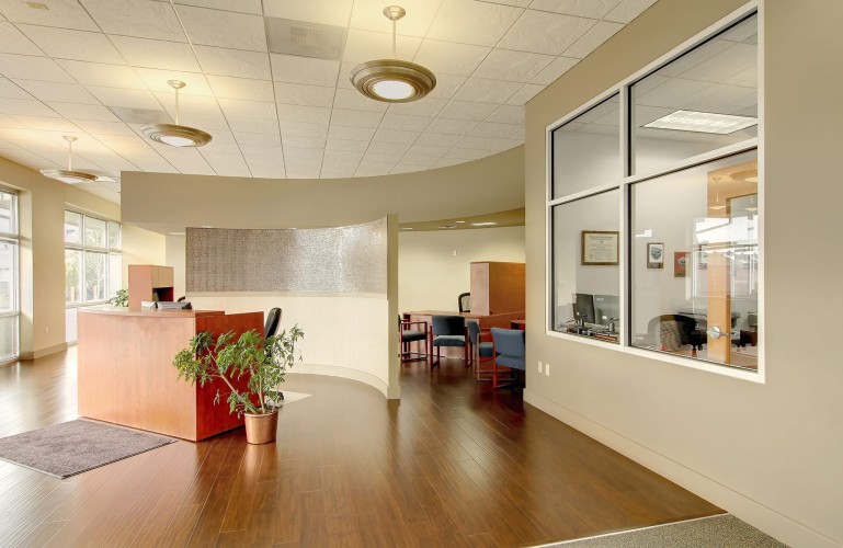 Business entryway with wood flooring and a geometric layout