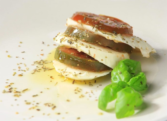 Close up of caprese plated with herbs and spices