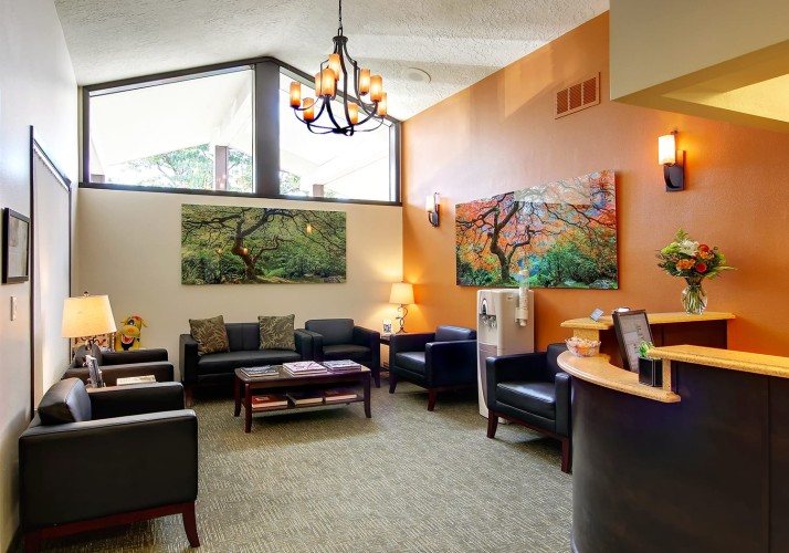 Interior of an office reception area with neat furnishings and beautiful photos