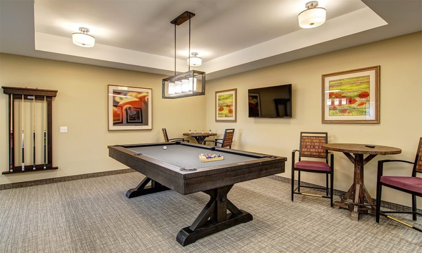 Game area with billiards table and seating with high tables
