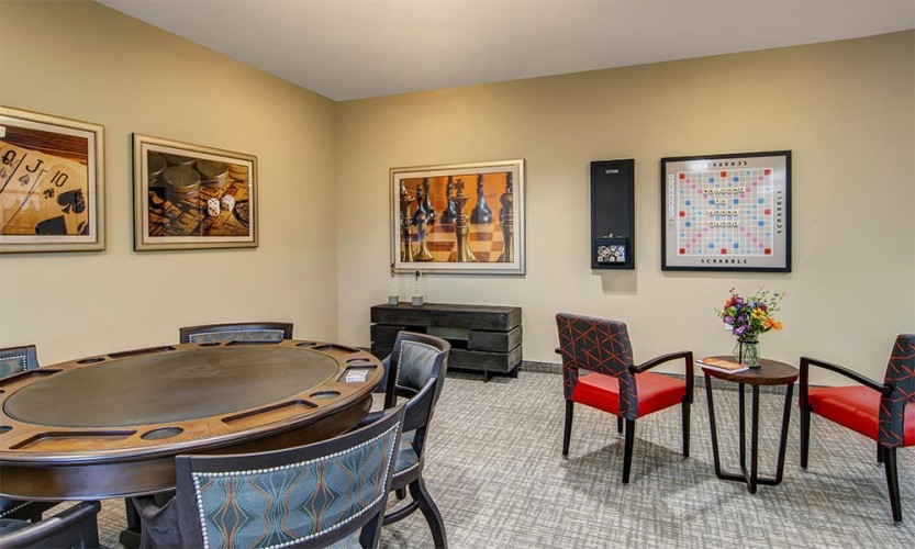 Game area with poker/card table with 6 seats and wall scrabble with magnetic tiles