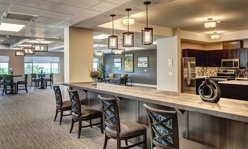 Bar with chairs next to the kitchen