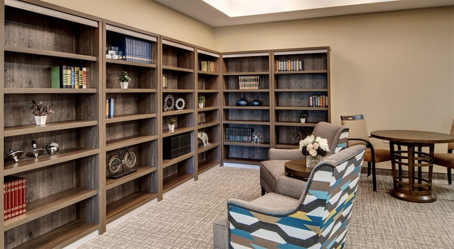 Library space with seating and blue, yellow, and brown accent colors