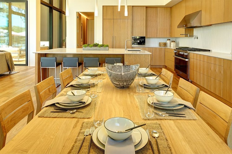 Light wood dining table looking towards the kitchen