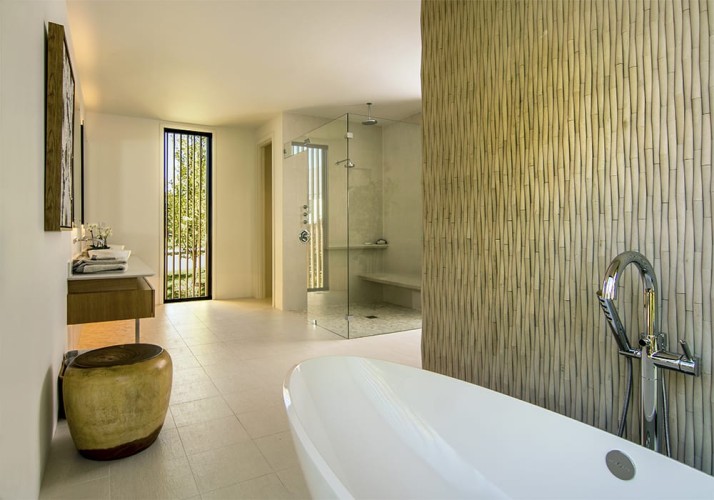 Bathroom with a bathtub, walk-in shower, and a couple bamboo walls