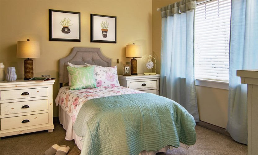 Small bedroom with mint, pink, and blue accent colors