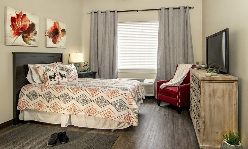 Small bedroom/living space with red, orange, and black accent colors