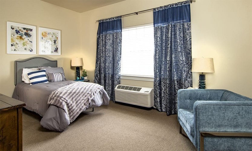 Small bedroom with simple, elegant, blue them and cheerful pastel yellow walls